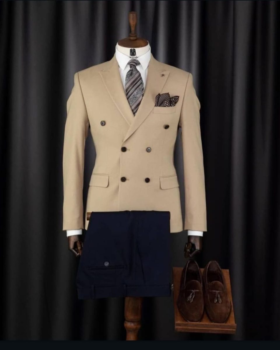 Beige three-piece suit with contrast navy trousers, daytime look