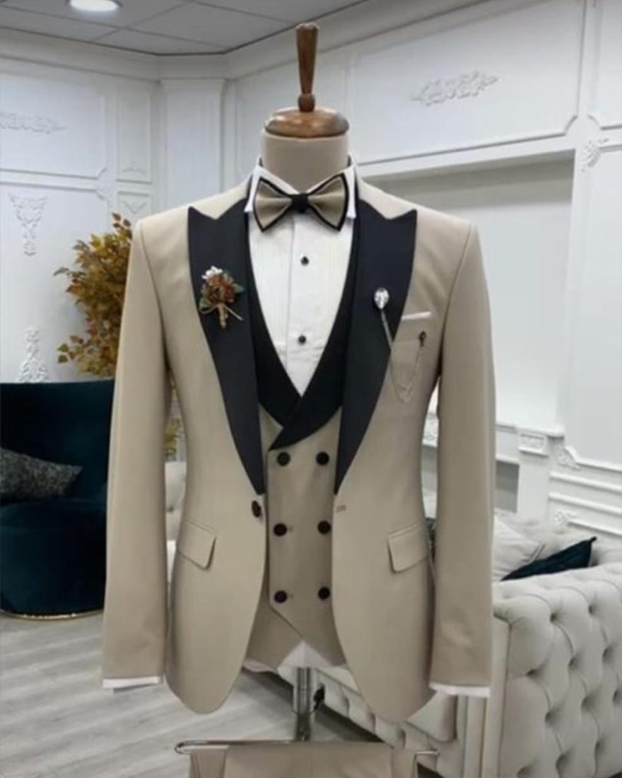 Cream double-breasted tuxedo with black peak lapel and bow tie
