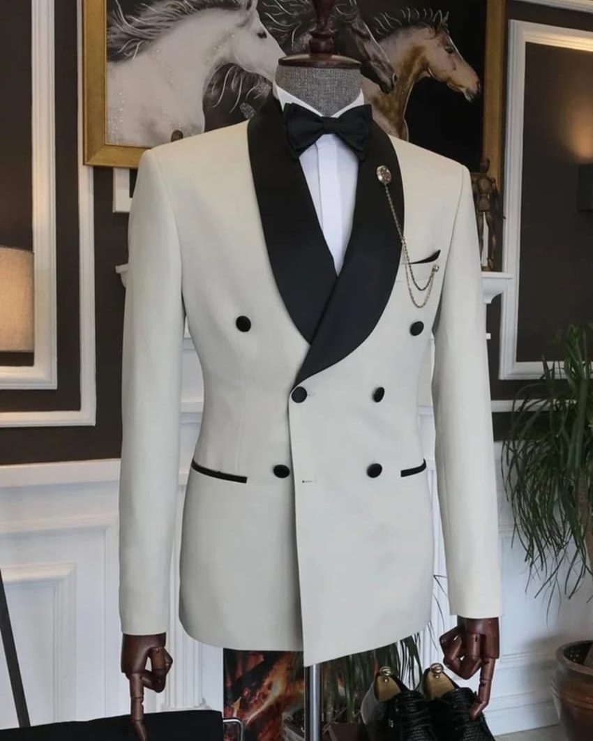 Ivory double-breasted tuxedo with black shawl lapel, styled in a boutique fitting room